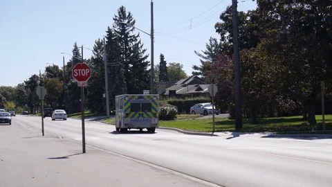 Ambulance driving down street Stock Footage 70069979
