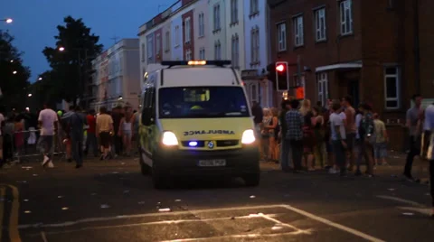 Ambulance Driving Through Crowd of People - St Paul's Carnival Stock Footage 33140336