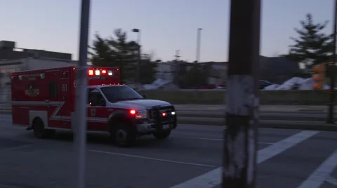 Ambulance driving through intersection Stock Footage 59990855