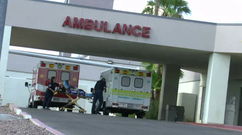 Ambulance EMT Wheels Patient Into Hospital ED Stock Footage