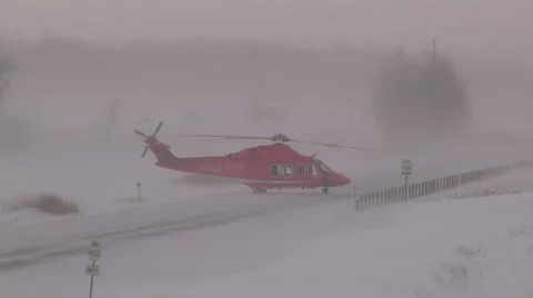 Ambulance helicopter stranded on highway in blizzard and snow squalls Stock Footage 46880296