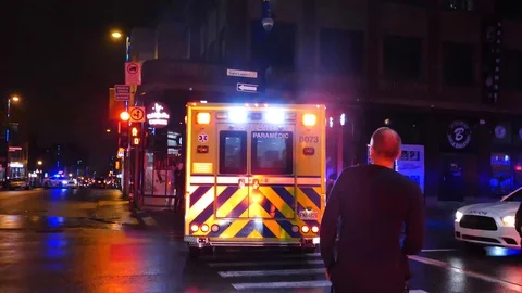 Ambulance leaving with homicide victim downtown Stock Footage 101994424