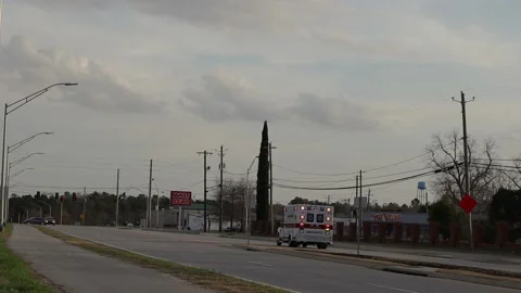 Ambulance with lights on going down the road Stock Footage 149454003