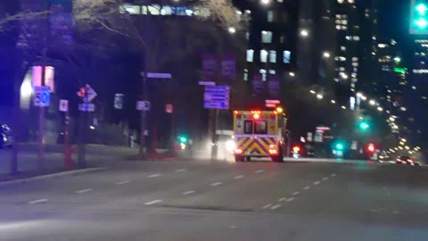 Ambulance with lights sirens followed by police cars Stock Footage 138600113