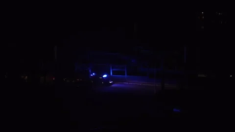 Ambulance moving through the dark streets of the city Stock Footage 231706007