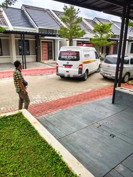 An ambulance is parked in reverse in a housing complex. Stock Photos