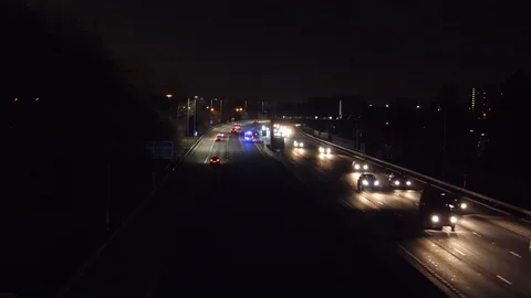 Ambulance is rushing on Manchester M60 motorway at night Stock Footage