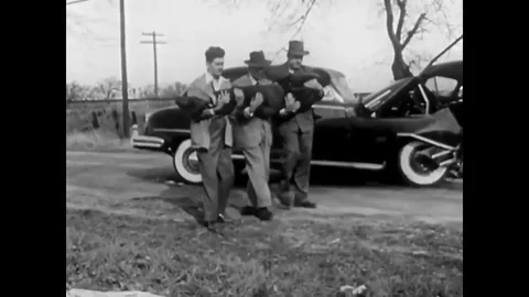 An ambulance shows up to help a man seriously injured in a car accident 1950 Stock Footage 101200810