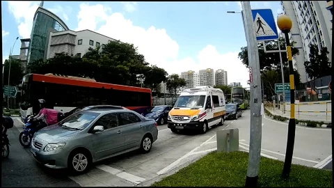 Ambulance sirens blaring at junction Stock Footage 128523641