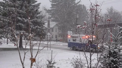 Ambulance in snow storm Stock Footage 98058152
