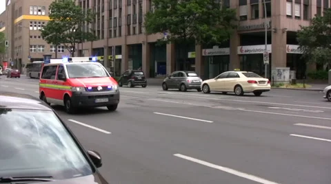 Ambulance speeding down road in Germany panned view Video stock 51861535