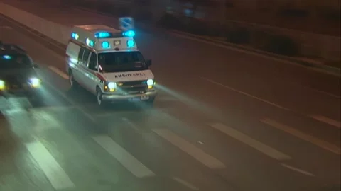 Ambulance speeding on the road at night Stock Footage 253771476