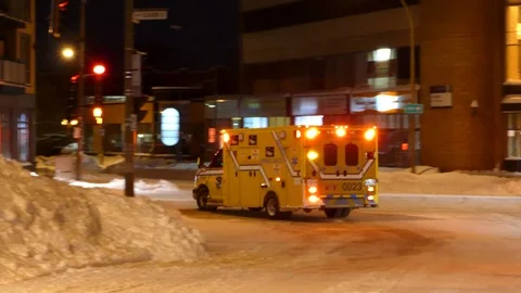 Ambulance using rumbler deep frequency siren at night in winter Stock Footage 85295648