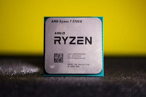 Amd ryzen 5700x processor close-up with yellow background Stock Photos