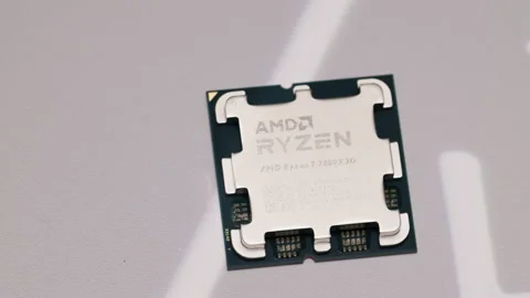 AMD Ryzen 7 7800X3D CPU close-up on a tray. Perfect for tech reviews or Stock Footage 301168427