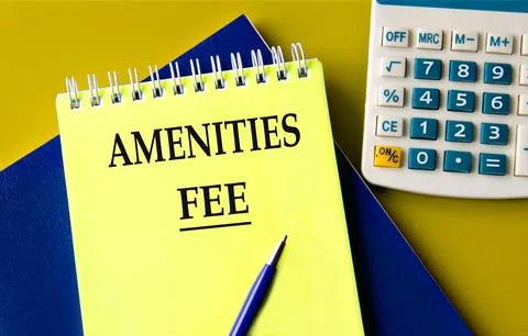 AMENITIES FEE - words on a yellow notepad with a calculator Stock Photos