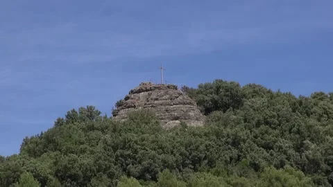 Amer cross mountain peak forest trees stone sunlight Stock Footage 317829152