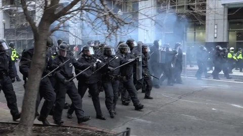 America January 2017 - Riot police and batons march forwards during protests Stock Footage