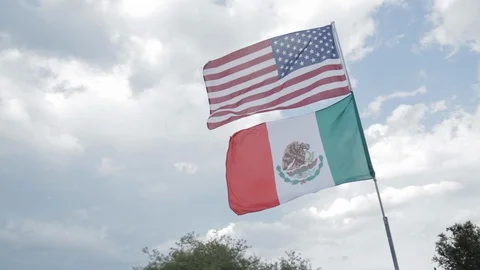 American and Mexican flags in front of sky Video stock 90932636