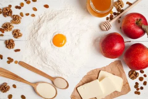 American apple pie preparation in rustic kitchen. Raw ingredients on white table Stock Photos