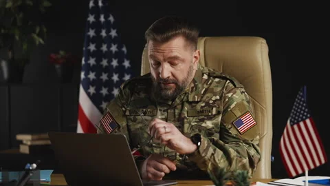 American army general feeling work stress while planning operations on laptop Stock Footage 334668824