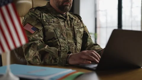 American army intelligence officer analyzing data and typing reports on laptop Stock Footage 331497472