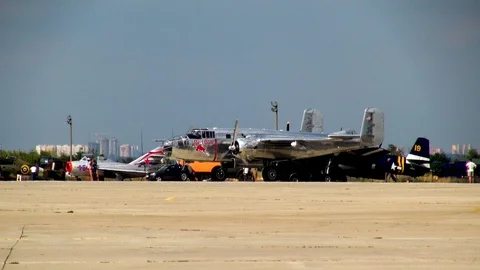 American B-25 Mitchell bomber leaves parking lot in direction runway. Stock Footage 118637599