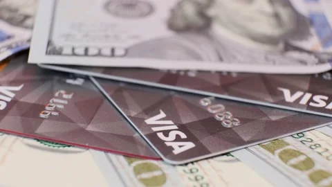 American Banknotes of 100 Dollars and Black Plastic Credit Cards Visa Video stock 138709641