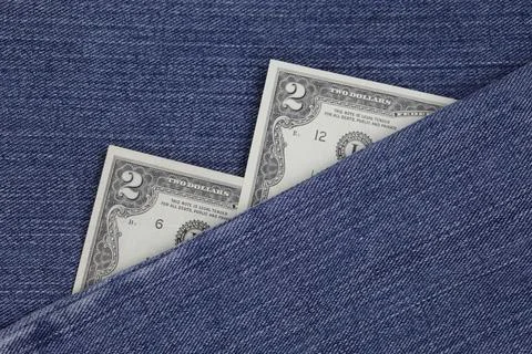 American banknotes of two dollars between blue denim fabric Foto stock