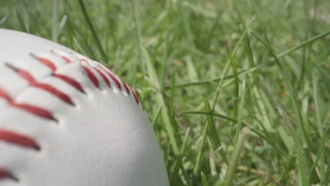 American baseball lying in the grass on the field macro close up Stock Footage 130748522