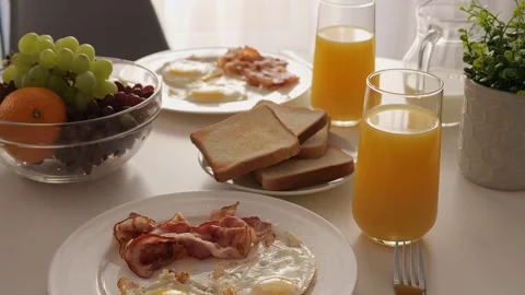 An American breakfast with eggs is on table. Scrambled eggs, sunny side up Stock-Footage 276158171