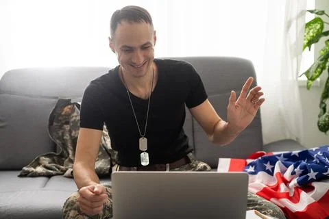American caucasian soldier in USA military uniform in front of the computer. Stock Photos