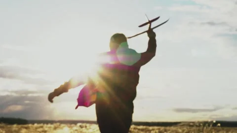 American child boy runs through park with toy plane his hand sunset sky 스톡 동영상 244549733