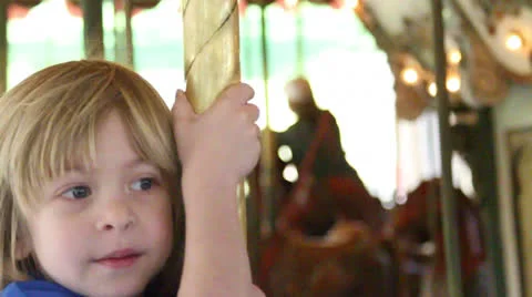 American child plays the carousel Stock Footage 22795174