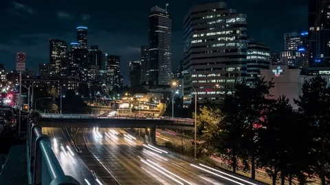 American City Night Time-Lapse of Freeway Cars and Skyscraper Buildings Stock Footage