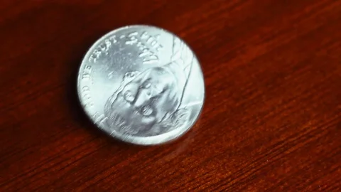 American coin nickel falling down on a table Stock Footage 106574976