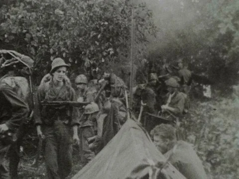 An American combat team hikes down a summit in the Kumon Mountain Range in 1944 Stock Footage 75298765