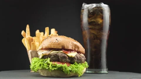 American combo, tasty beef burger with crispy french fries and cold cola on.. Stock Footage 233398749