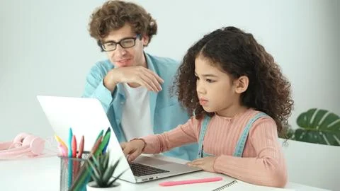 American daughter learning to coding and writing engineering prompt. Pedagogy. Stock Photos