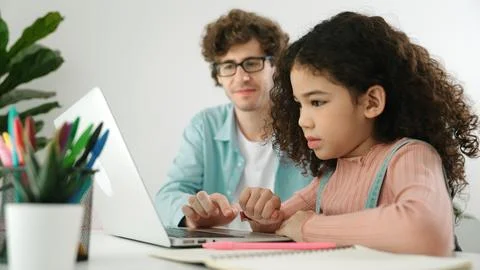 American daughter learning to coding and writing engineering prompt. Pedagogy. Stock Photos