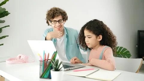 American daughter learning to coding and writing engineering prompt. Pedagogy. Stock Photos