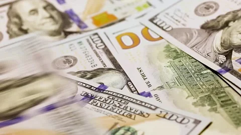 American dollar banknotes falling one after another on the table with shaking Stock Footage 169828083