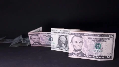American dollar bills falling in a domino effect revealing a Chinese one yu.. Stock Footage 318557448