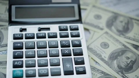 American dollars are on the table next to the calculator Stock Footage 123541480