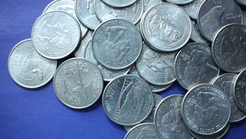 American dollars in a coin on a blue background. Close-up. Vídeo Stock 89463755