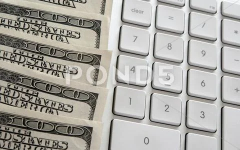 American dollars near computer keyboard calculator Stock Photos