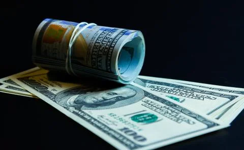 American dollars in roll and banknotes Stock Photos