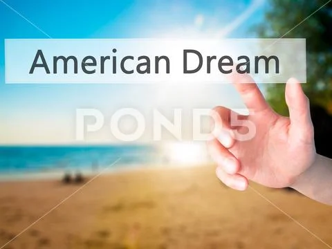 American Dream - Hand pressing a button on blurred background co Stock Photos