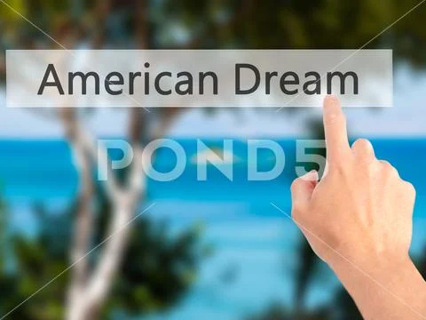 American Dream - Hand pressing a button on blurred background co Stock Photos