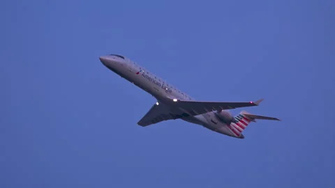 American Eagle CRJ-700 Taking Off at Dusk from Charlotte Douglas CLT Airport Stock Footage 146703904